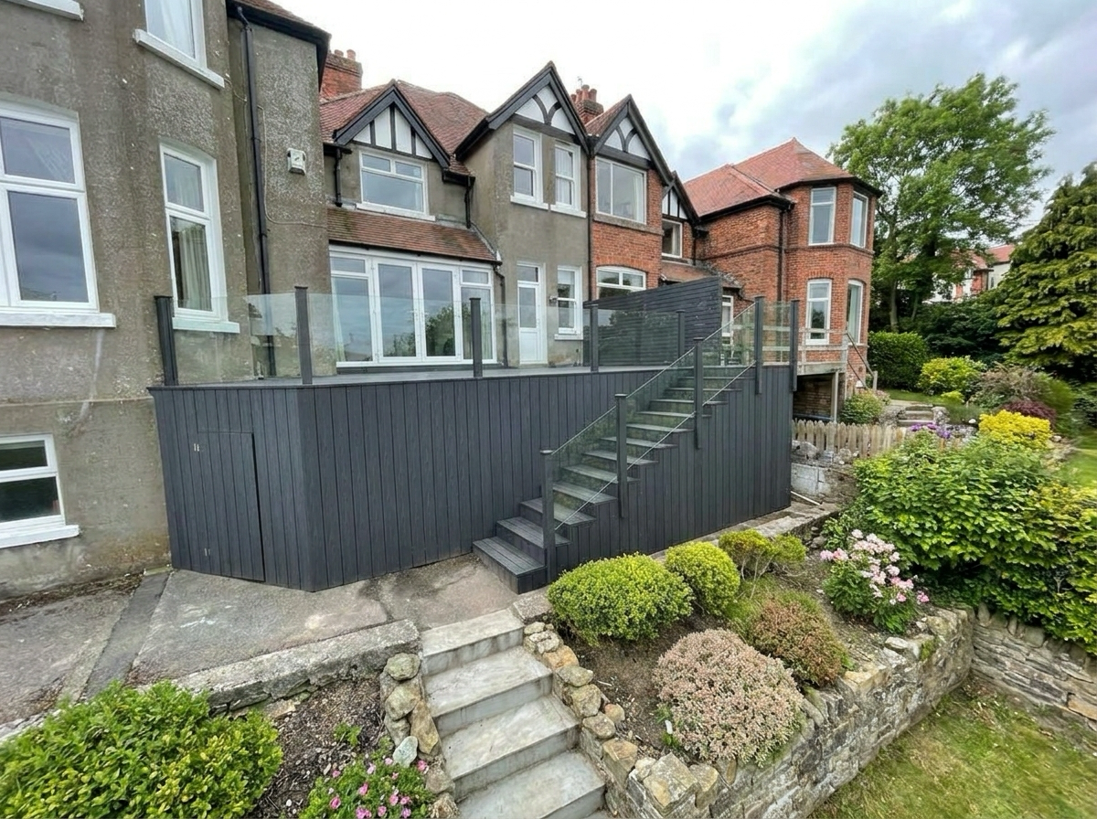 Charcoal composite decking with glass balustrade and external staircase — side angle