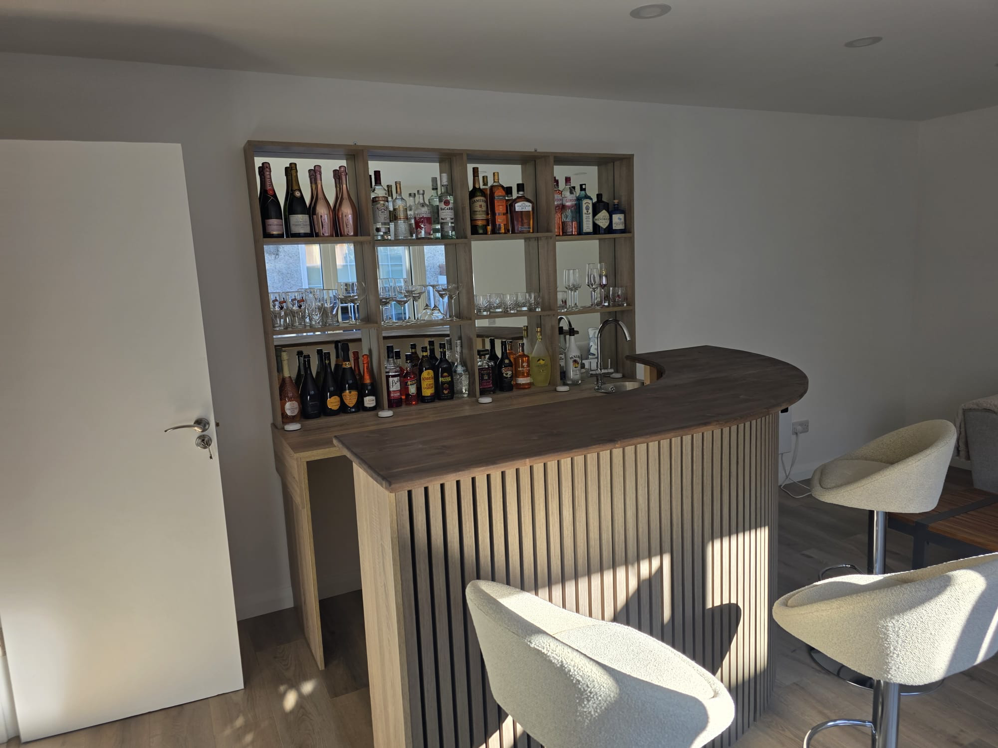 Bar unit from side angle showing shelving and counter