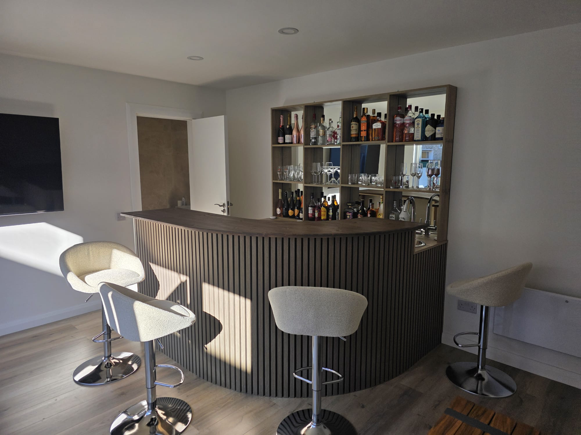 Full bar with curved slatted front and bar stools, garden lounge Dublin
