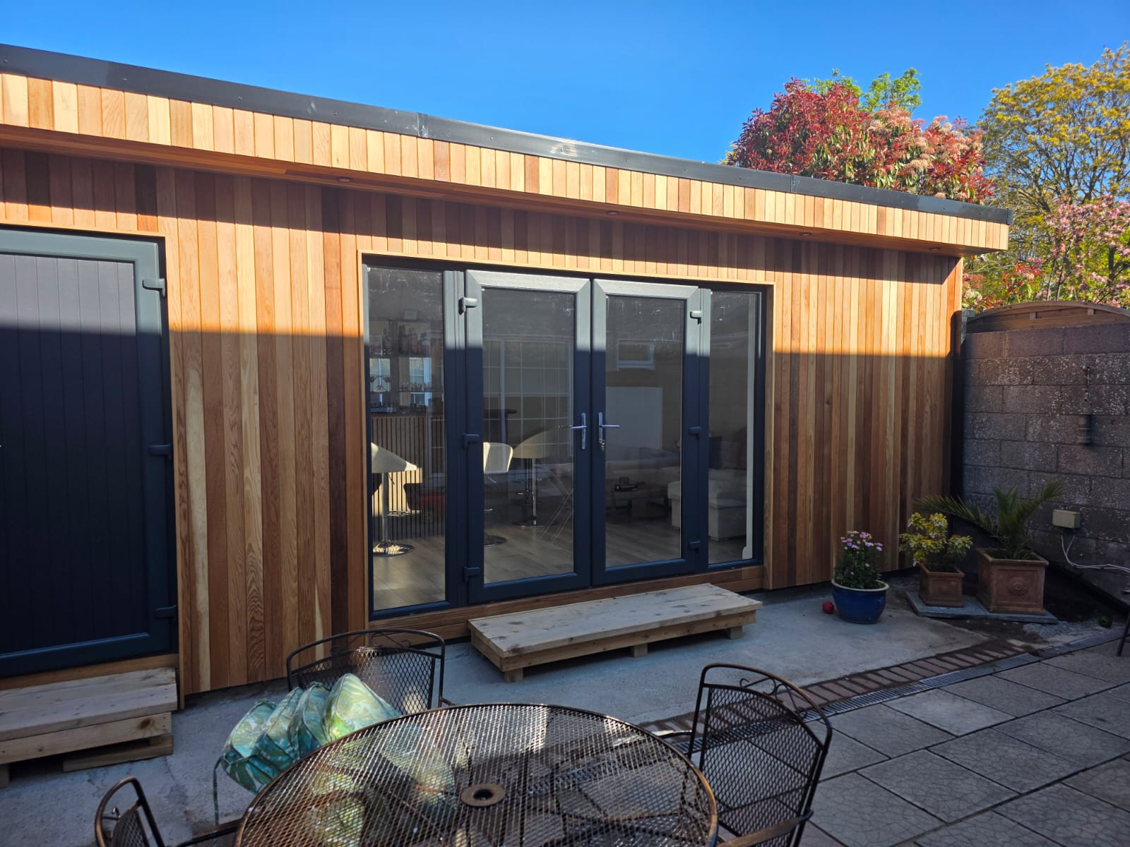 Cedar garden room with French doors, lounge and bar fit-out