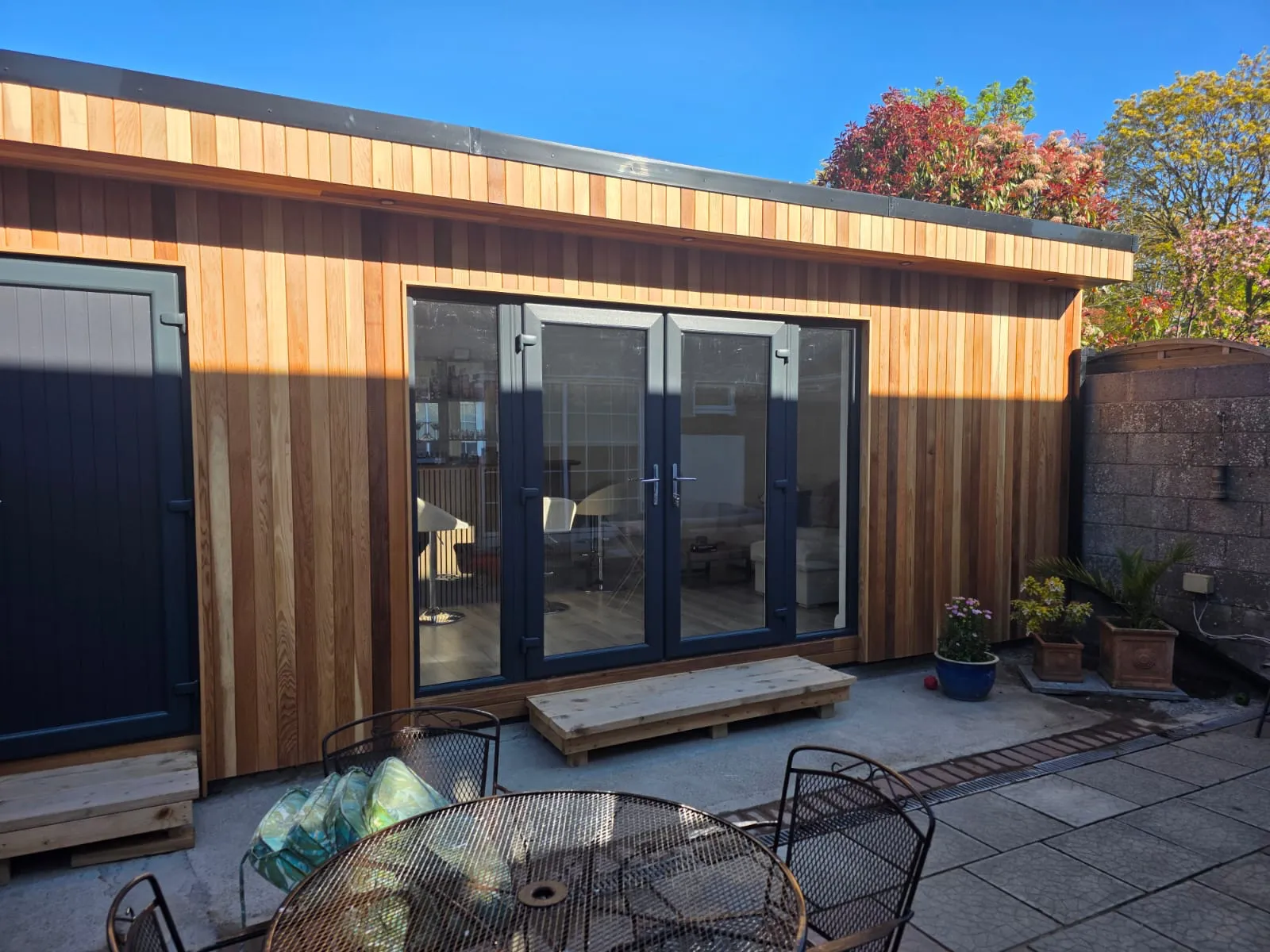 Cedar garden room with French doors, lounge and bar fit-out