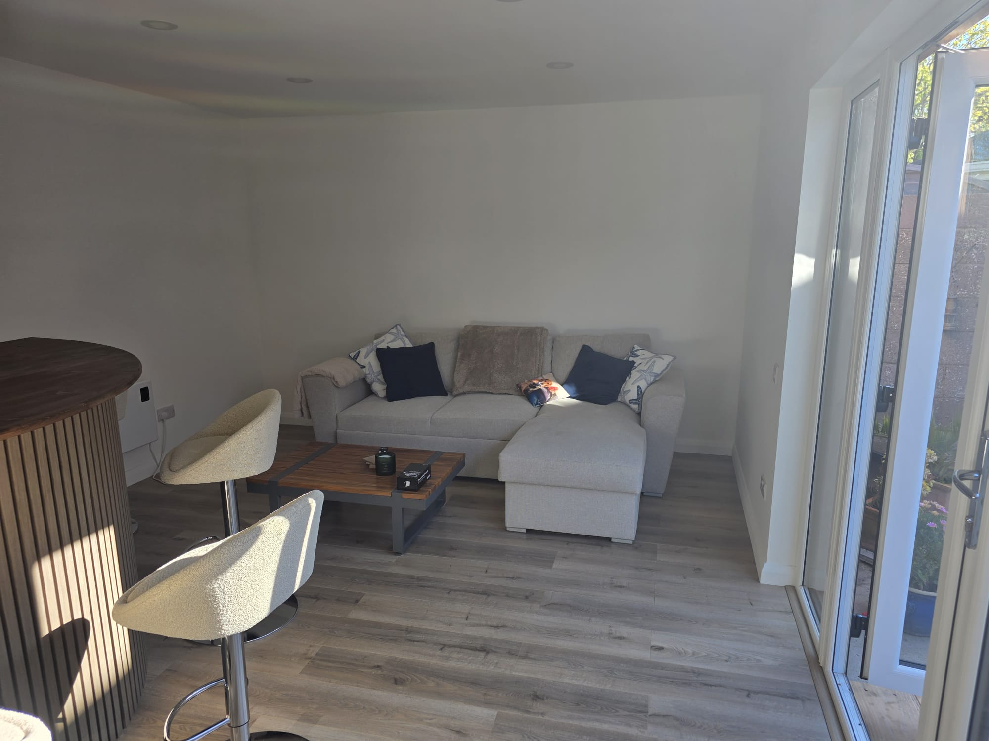 Garden lounge interior with sofa and French doors to garden