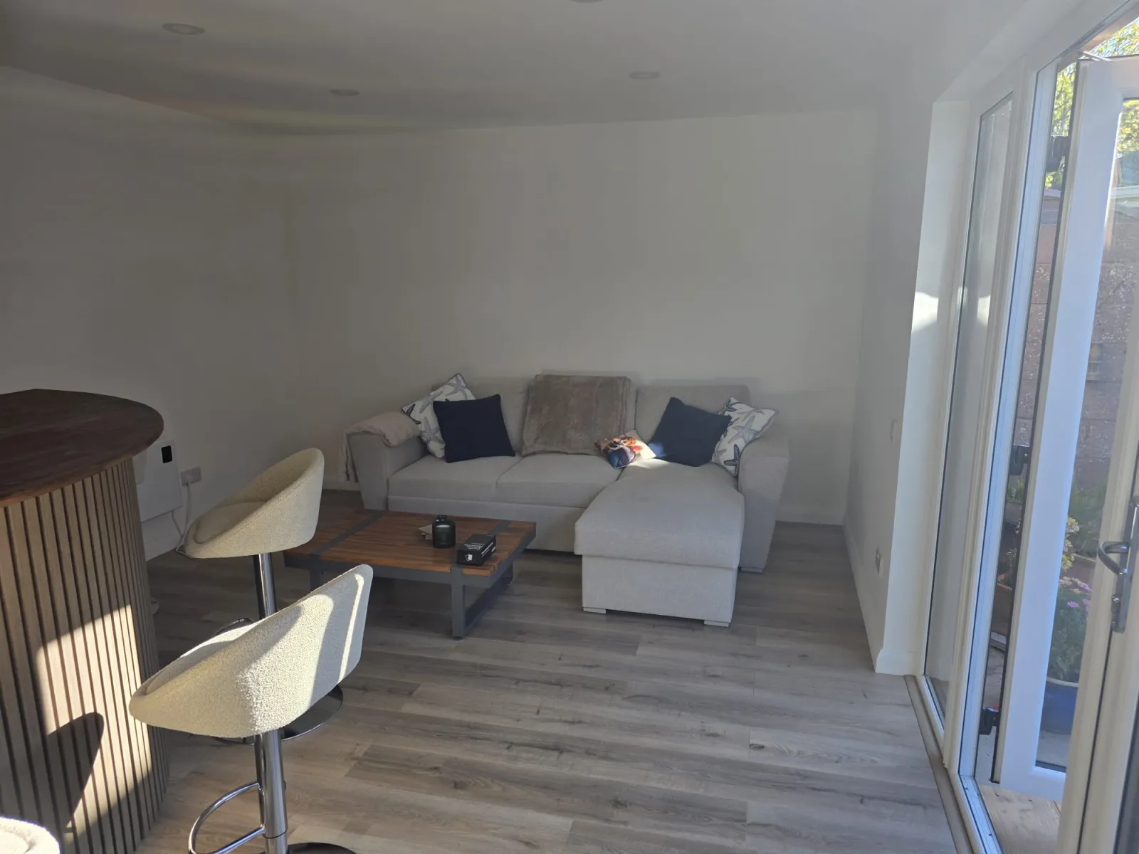Garden lounge interior with sofa and French doors to garden