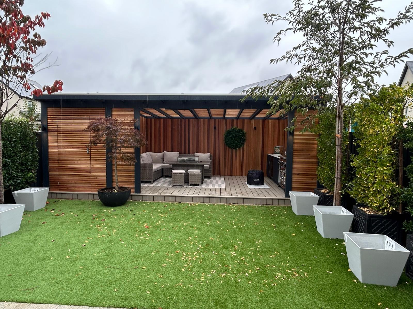 Anthracite louvred pergola with cedar feature walls and composite decking Dublin