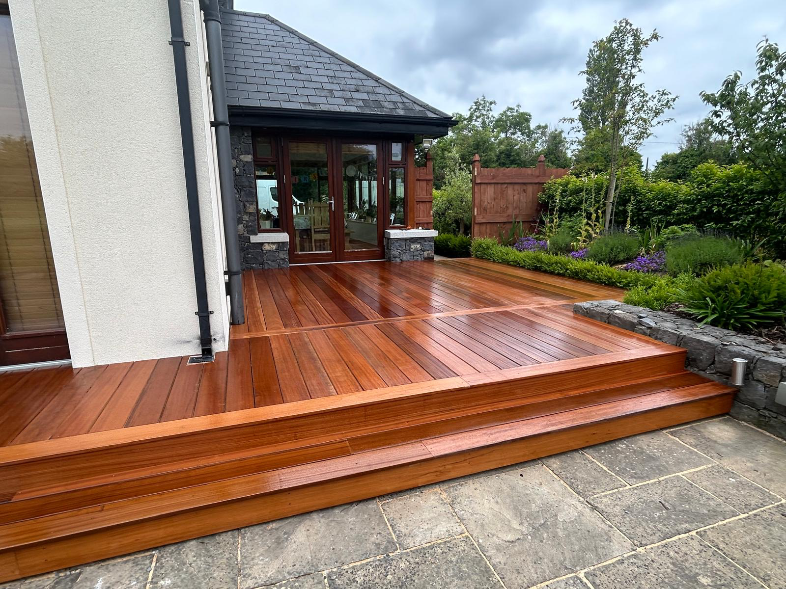 Hardwood decking with steps and stone planters