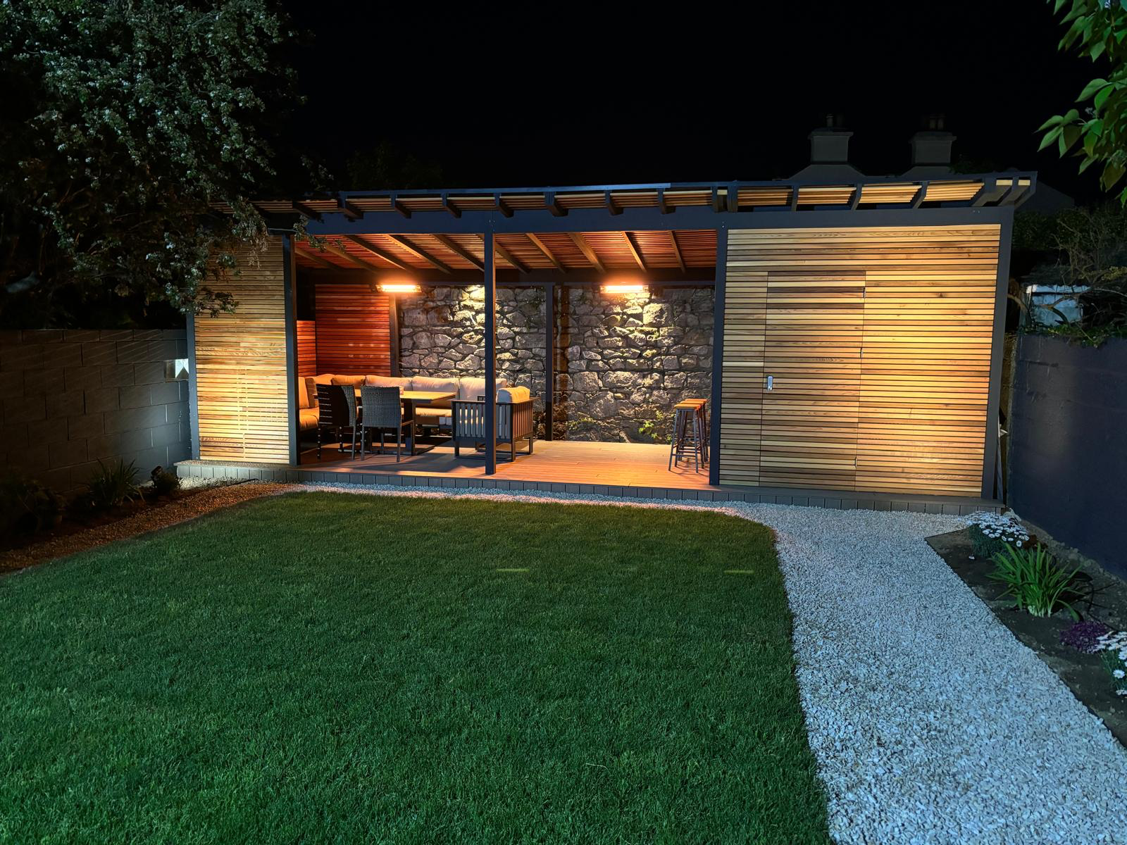 Illuminated pergola with stone feature wall evening Dublin