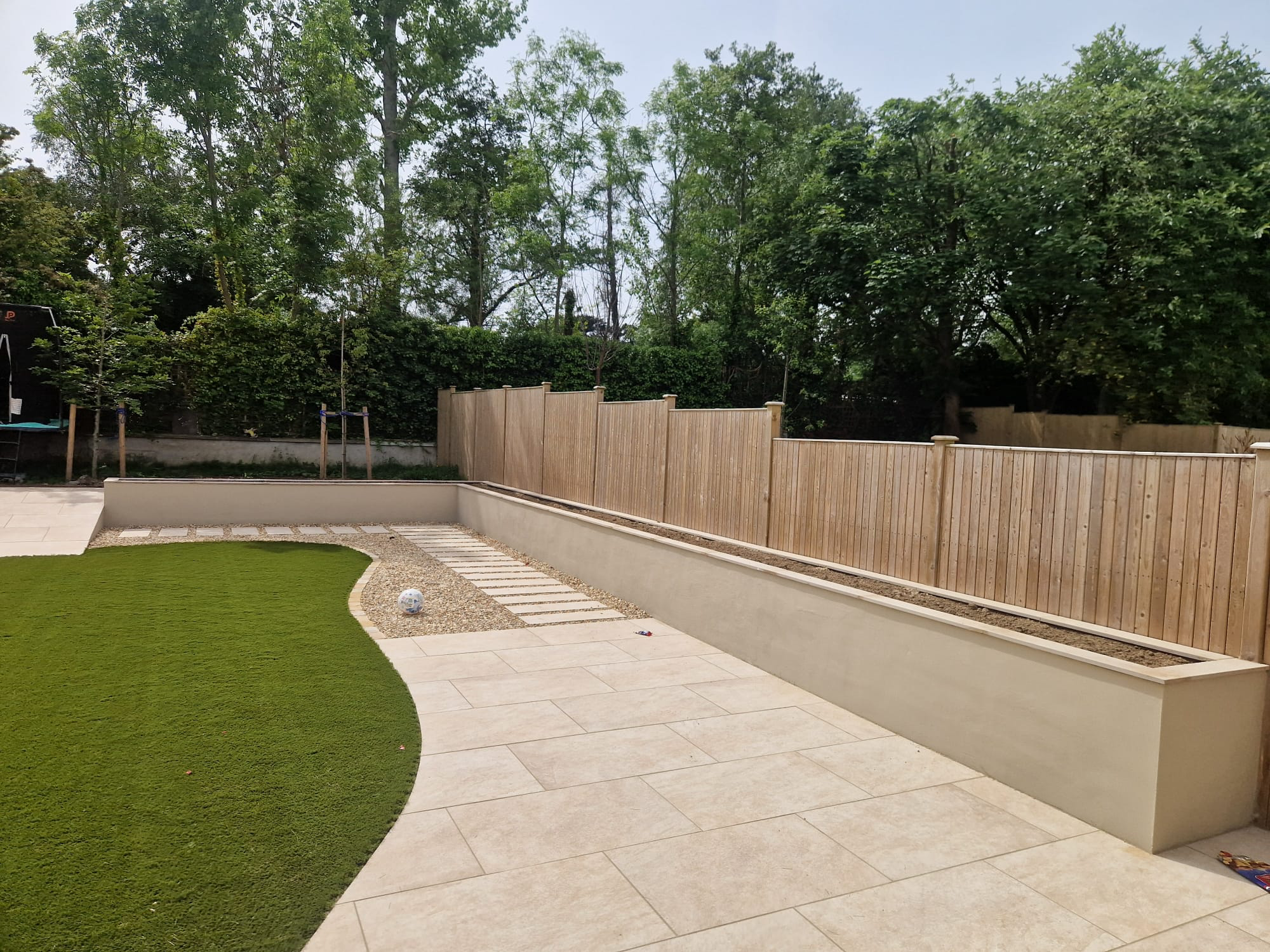 Limestone patio with curved artificial grass Dublin